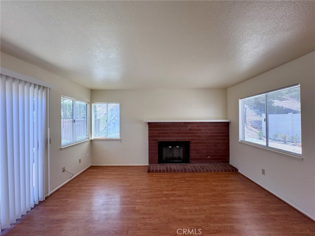 31585 Corte Salinas Temecula, CA 92592 - Photo 18 of 42 an empty room with windows and a fireplace