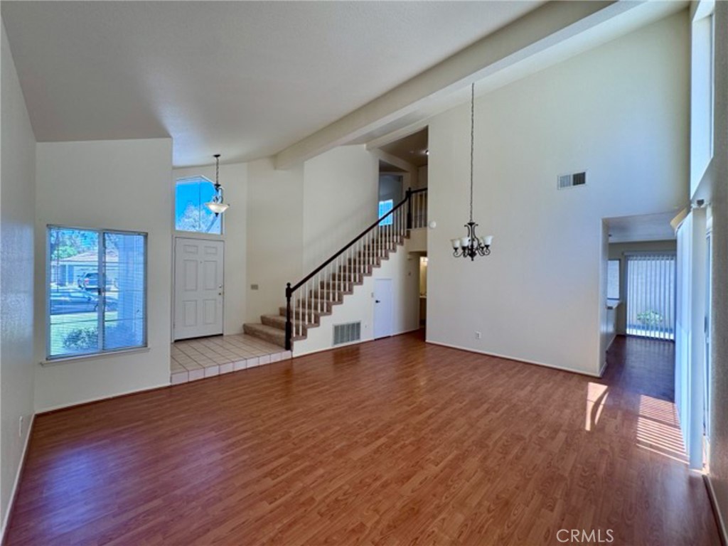 31585 Corte Salinas Temecula, CA 92592 - Photo 8 of 42 a view of an empty room with wooden floor and stairs