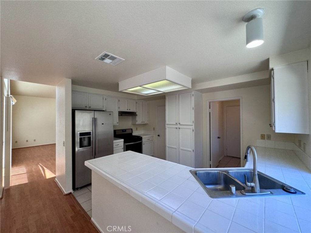 31585 Corte Salinas Temecula, CA 92592 - Photo 10 of 42 a kitchen with stainless steel appliances a refrigerator and a sink