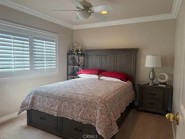 a bedroom with a bed and a baby crib