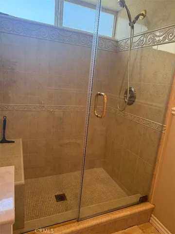 a en suite bathroom with a shower and a sink