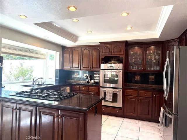 a kitchen with granite countertop stainless steel appliances and wooden cabinets