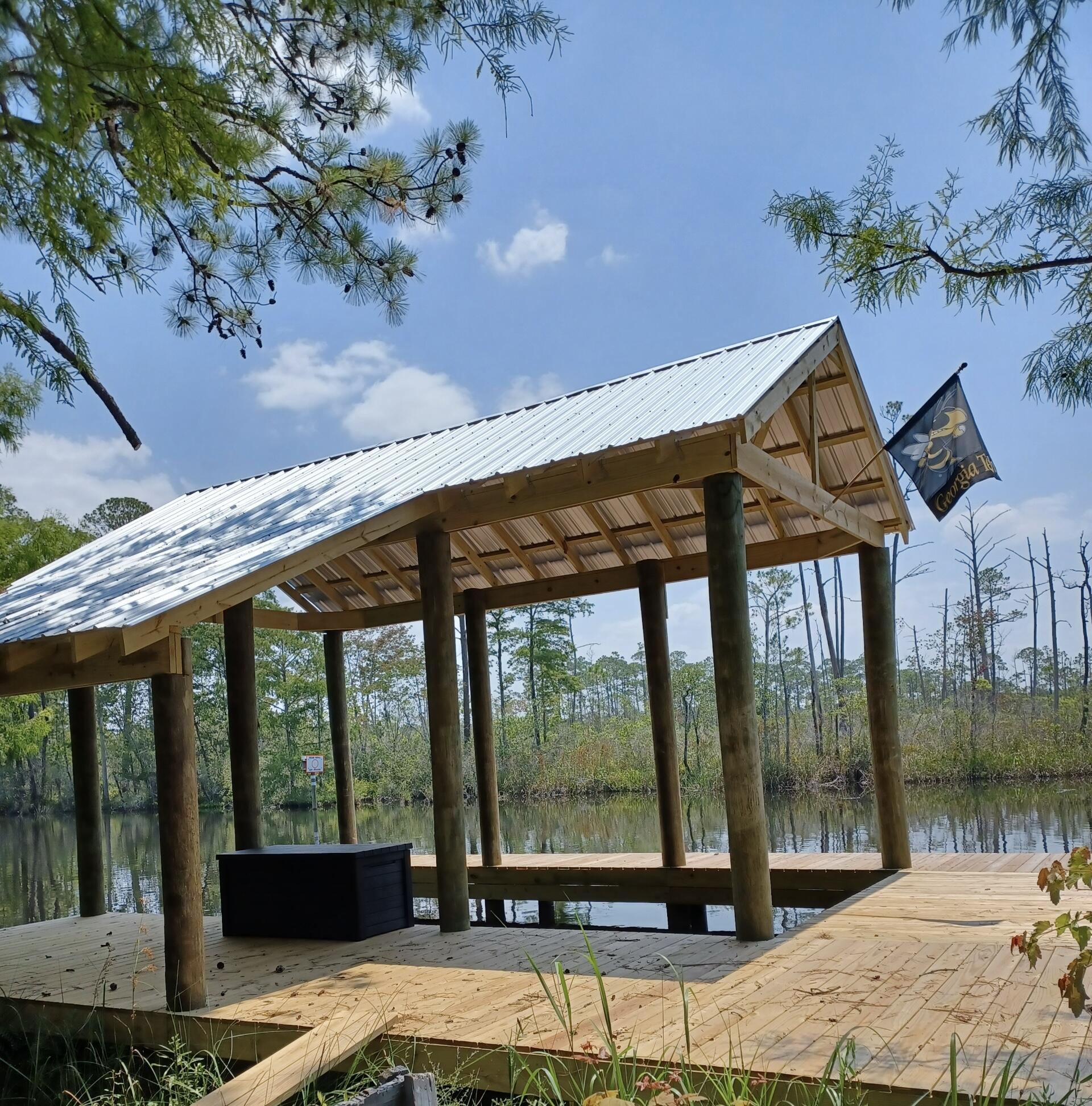 305 Portland Park Road Freeport, FL 32439 - Photo 5 of 7 a view of a patio with a table chairs and a backyard