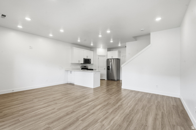 1173 West 1870 South Logan, UT 84321 - Photo 4 of 33 Open-concept living area featuring wood-finish flooring, recessed lighting, and a neutral color palette