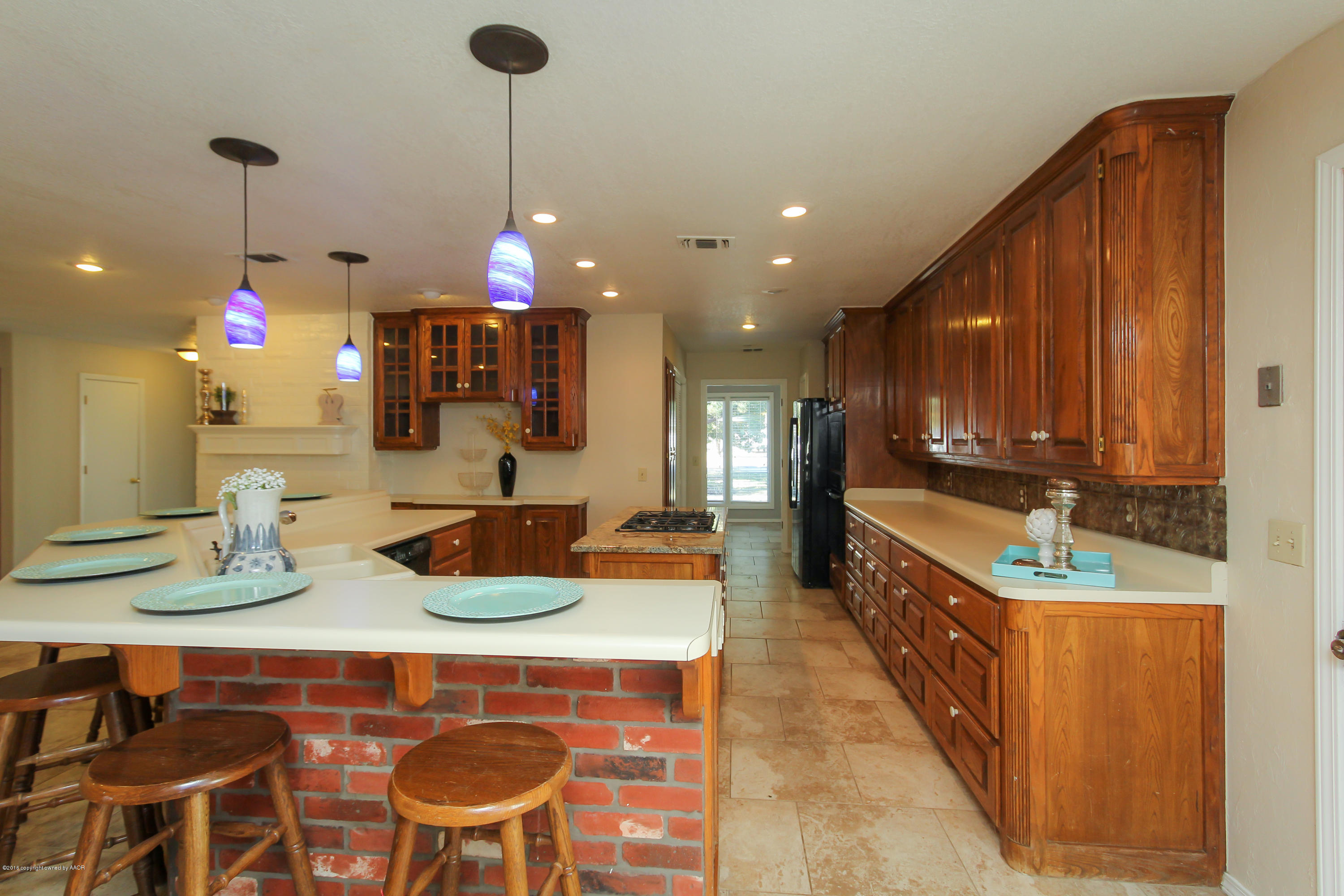 7915 Santa Fe Trail Amarillo, TX 79110 - Photo 12 of 57 a kitchen with stainless steel appliances granite countertop a sink and a white cabinets
