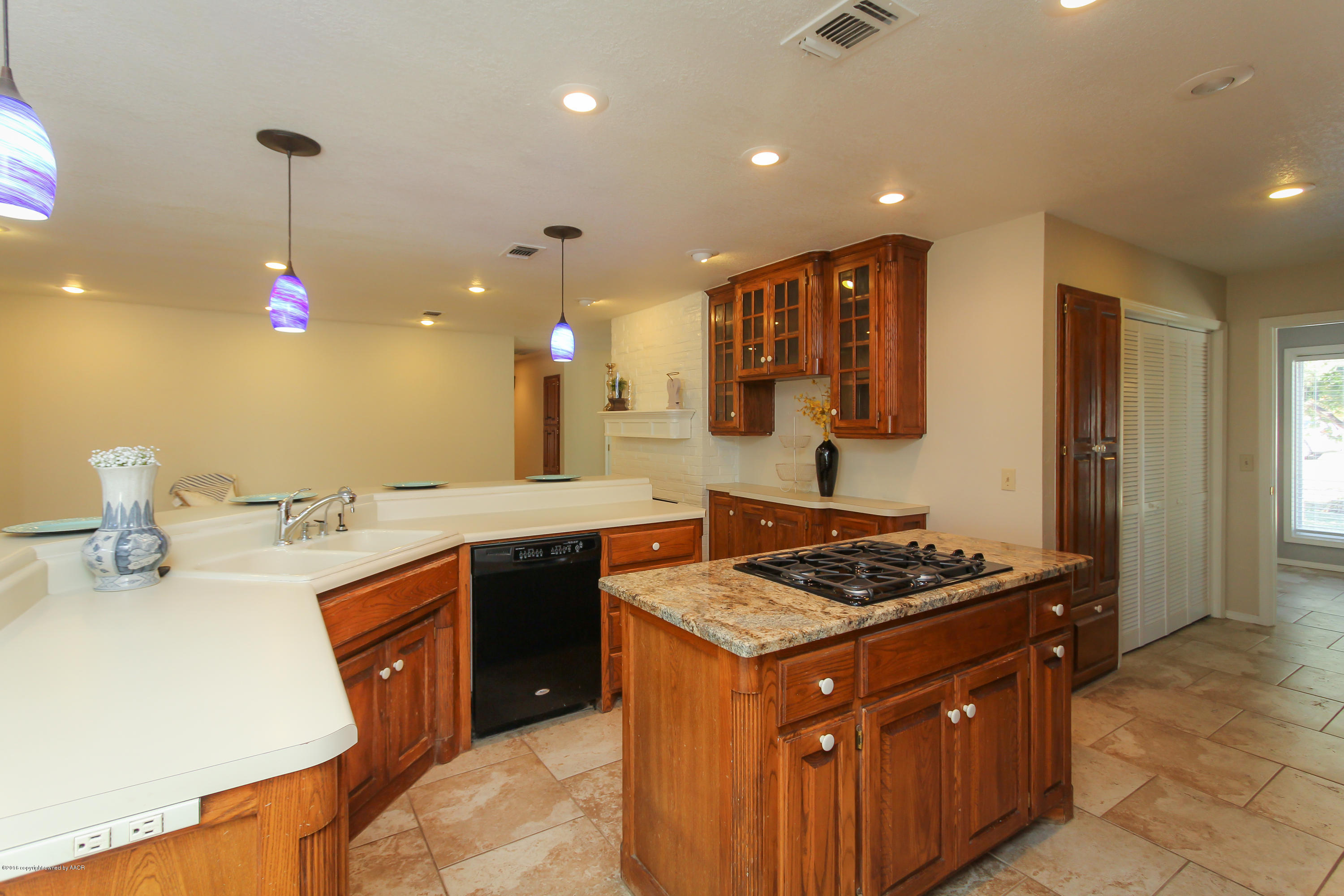 7915 Santa Fe Trail Amarillo, TX 79110 - Photo 14 of 57 a kitchen with stainless steel appliances granite countertop a stove a sink dishwasher and a microwave oven with cabinets