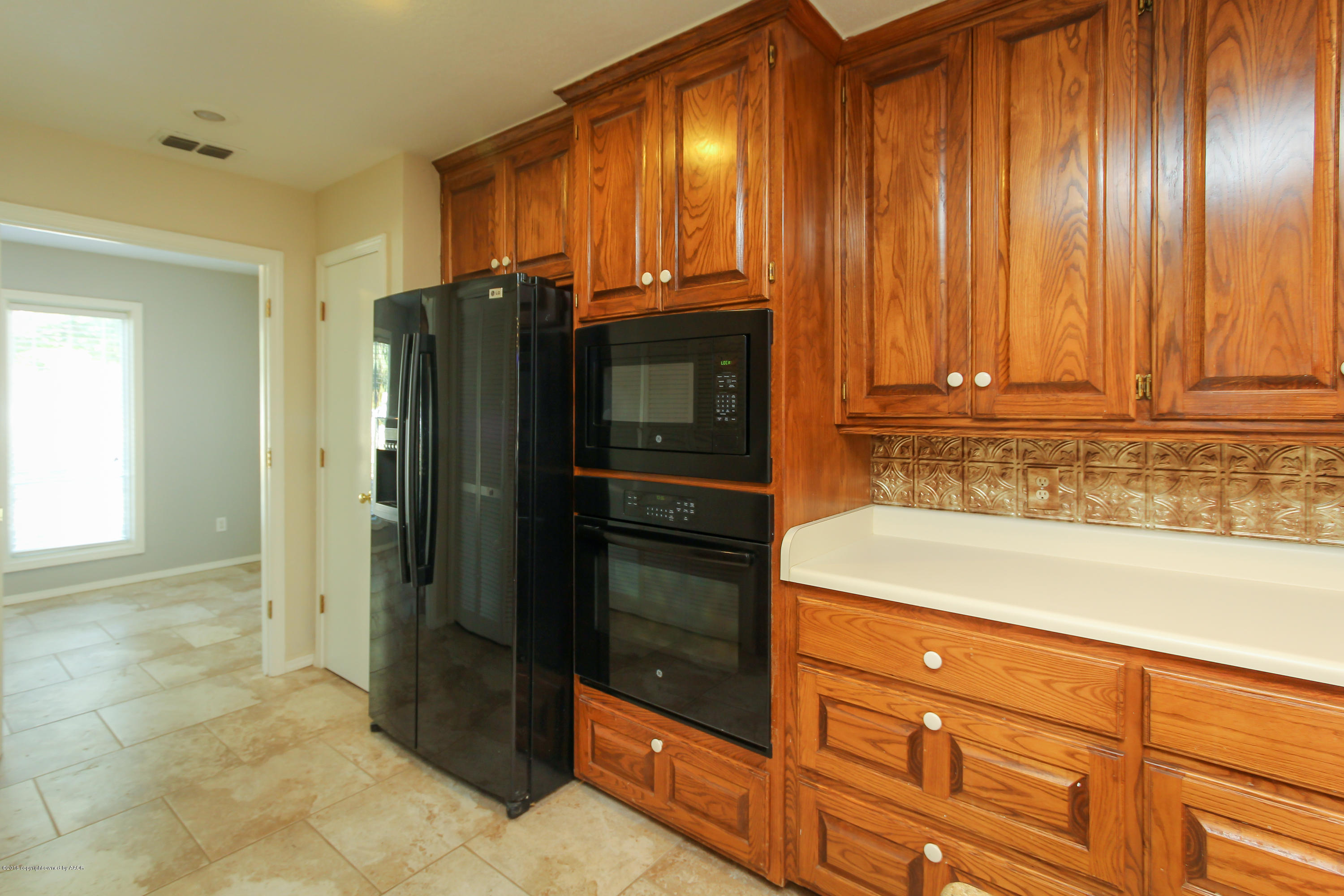 7915 Santa Fe Trail Amarillo, TX 79110 - Photo 15 of 57 a kitchen with stainless steel appliances granite countertop a refrigerator and a sink