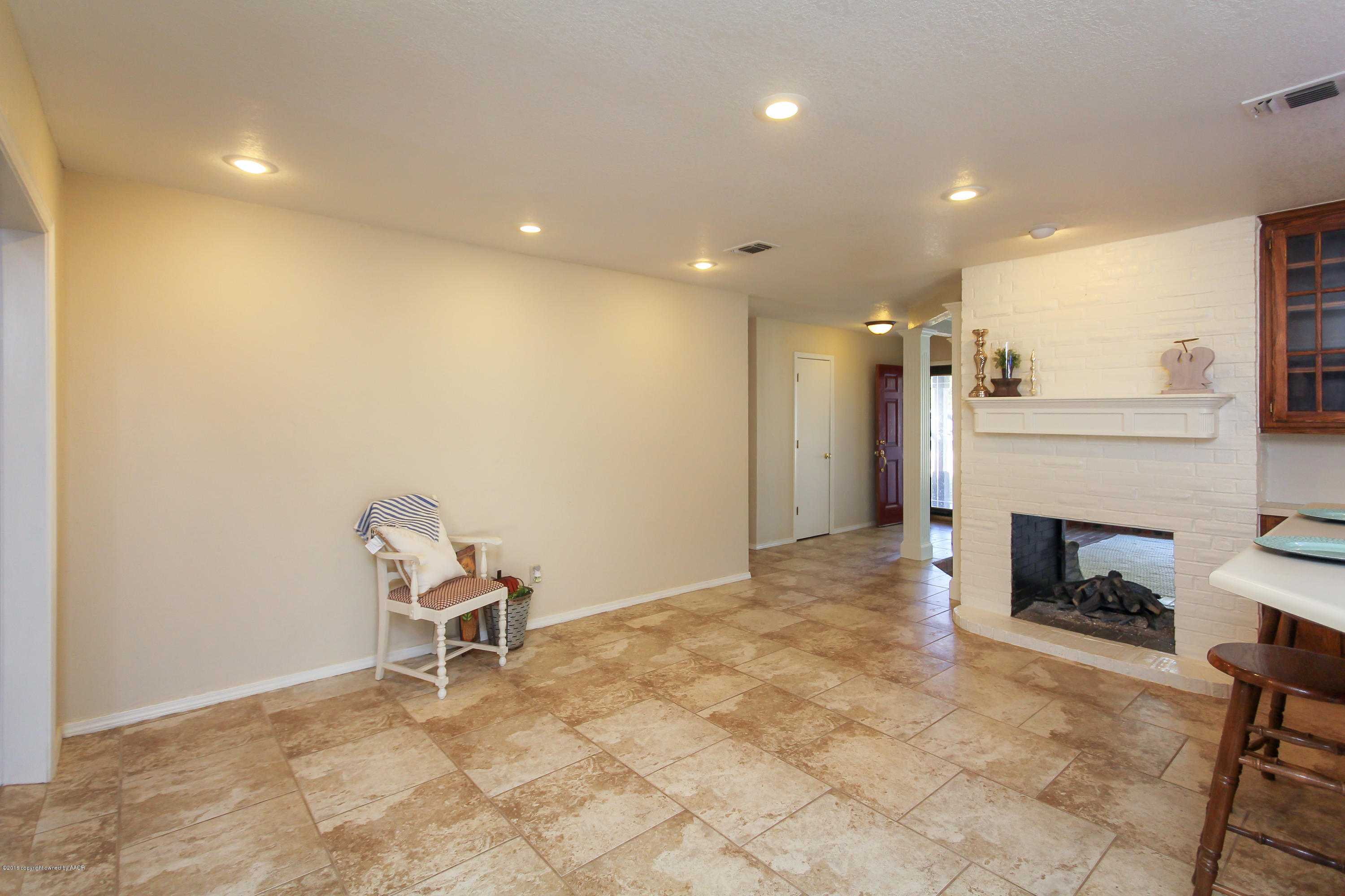 7915 Santa Fe Trail Amarillo, TX 79110 - Photo 18 of 57 a view of a livingroom with a fireplace and a workspace