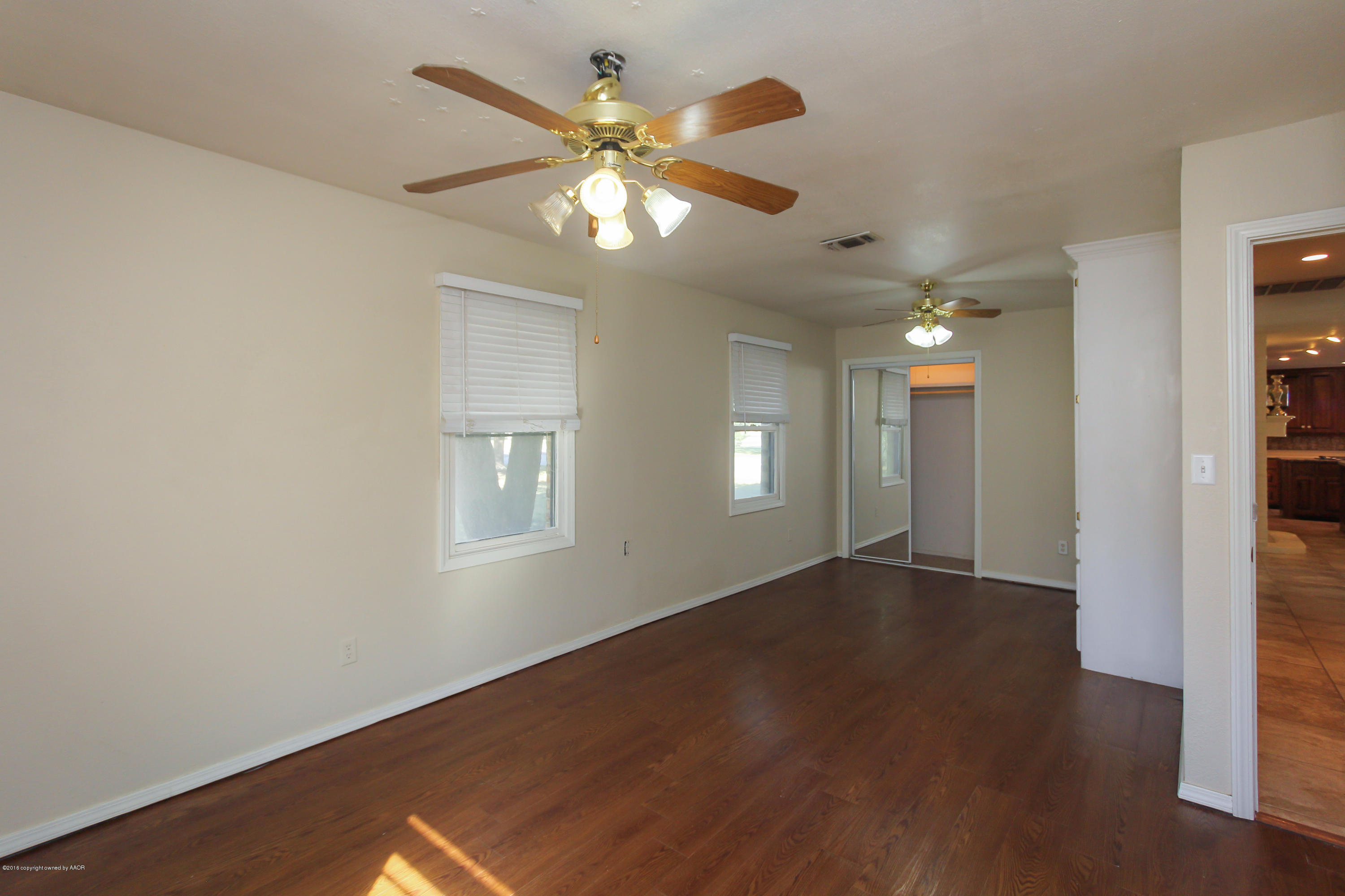 7915 Santa Fe Trail Amarillo, TX 79110 - Photo 23 of 57 an empty room with wooden floor closet and windows