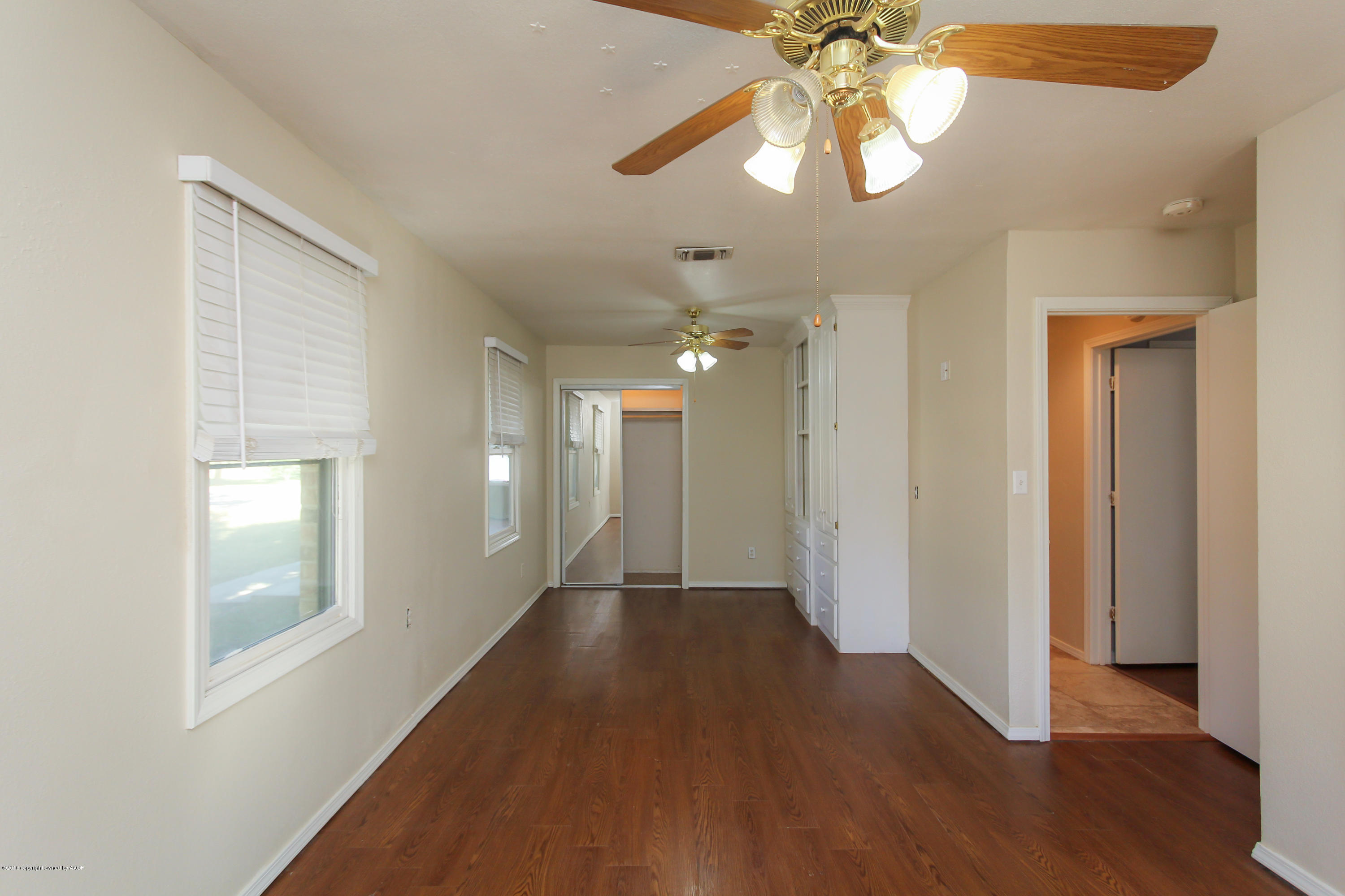 7915 Santa Fe Trail Amarillo, TX 79110 - Photo 24 of 57 a view of a hallway with wooden floor and chandelier fan