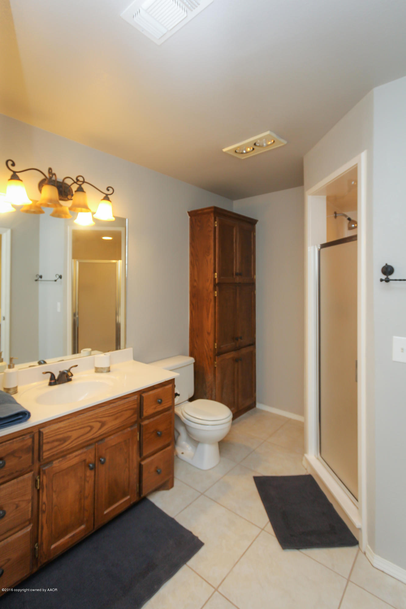 7915 Santa Fe Trail Amarillo, TX 79110 - Photo 25 of 57 a spacious bathroom with a double vanity sink a toilet and a mirror
