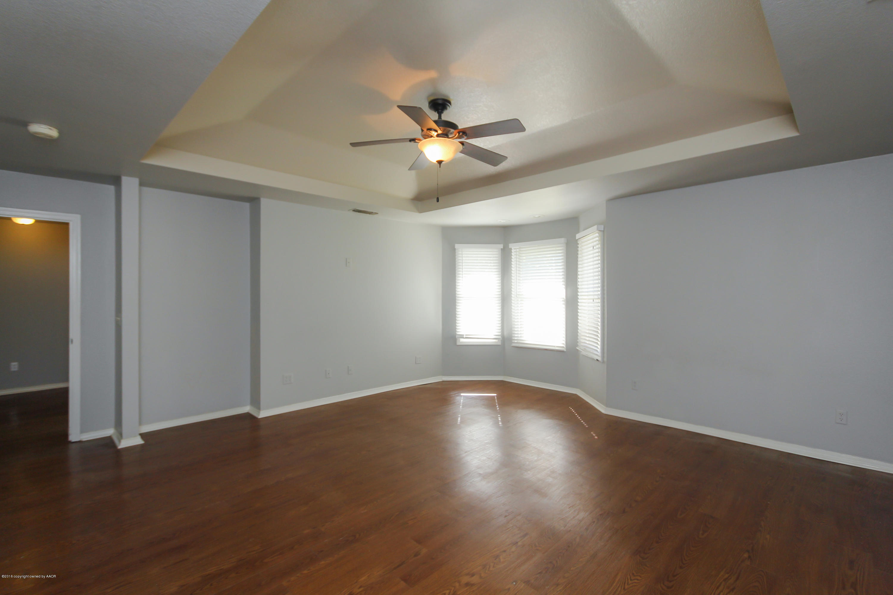 7915 Santa Fe Trail Amarillo, TX 79110 - Photo 30 of 57 a view of wooden floor and a chandelier fan in a room