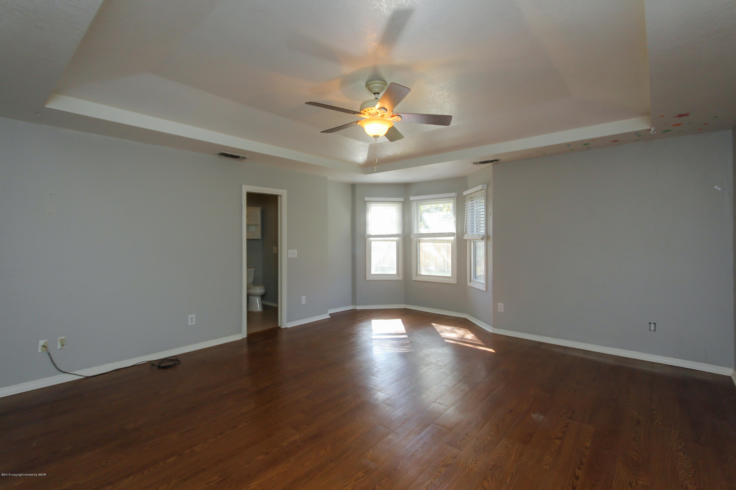 7915 Santa Fe Trail Amarillo, TX 79110 - Photo 32 of 57 a view of wooden floor and windows in a room