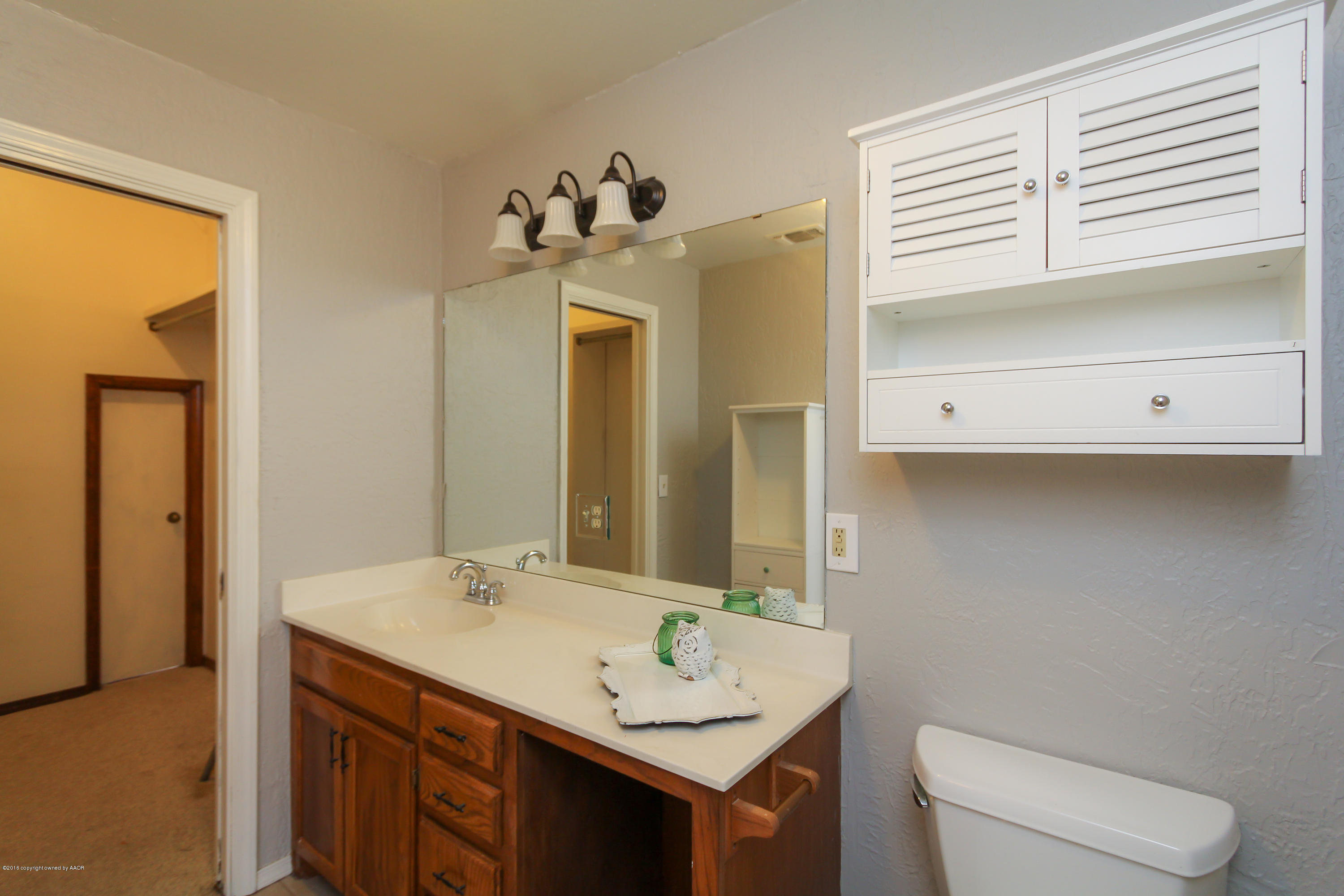 7915 Santa Fe Trail Amarillo, TX 79110 - Photo 36 of 57 a bathroom with a sink and a mirror