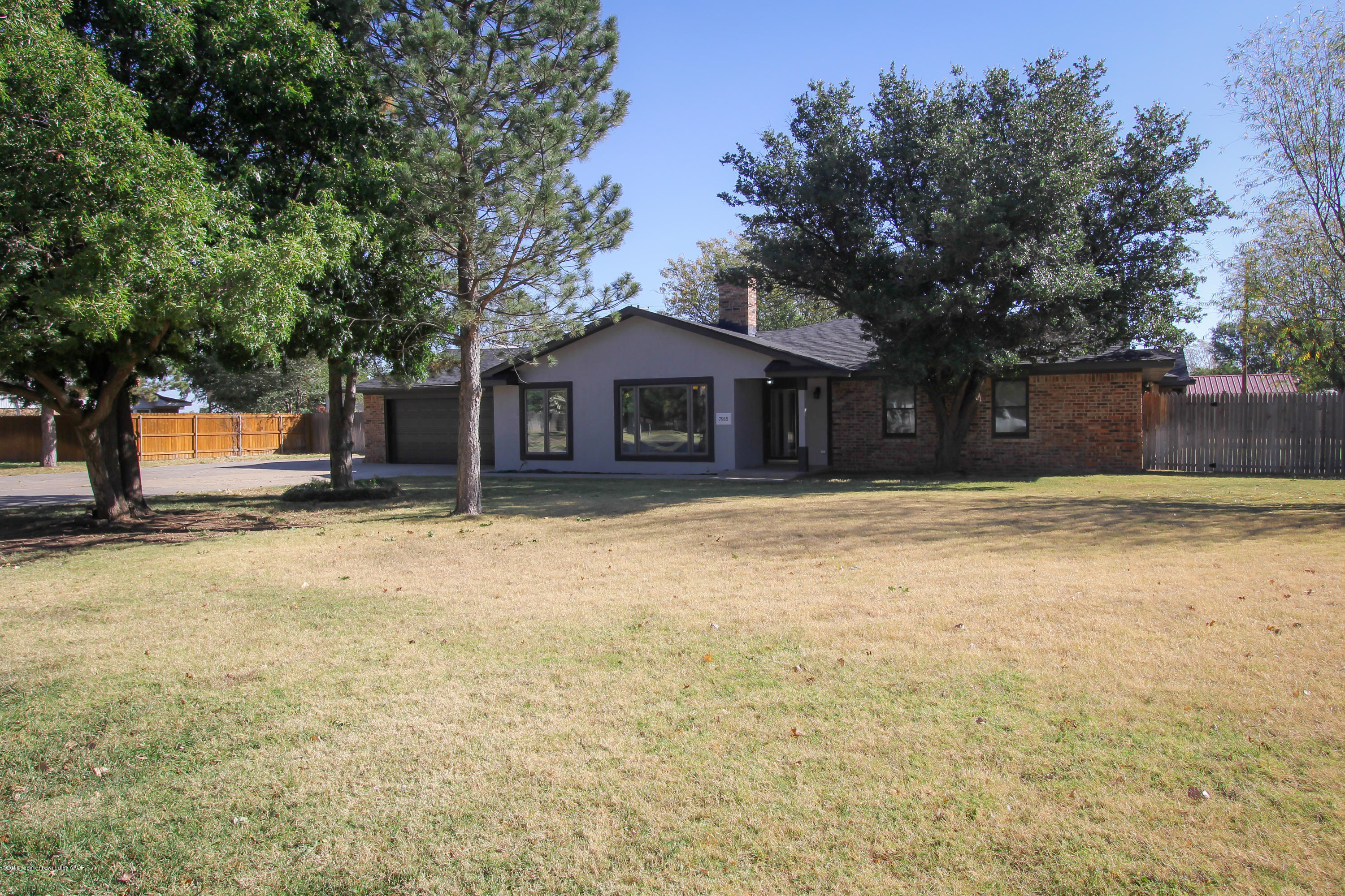 7915 Santa Fe Trail Amarillo, TX 79110 - Photo 37 of 57 a front view of a house with a yard and garage