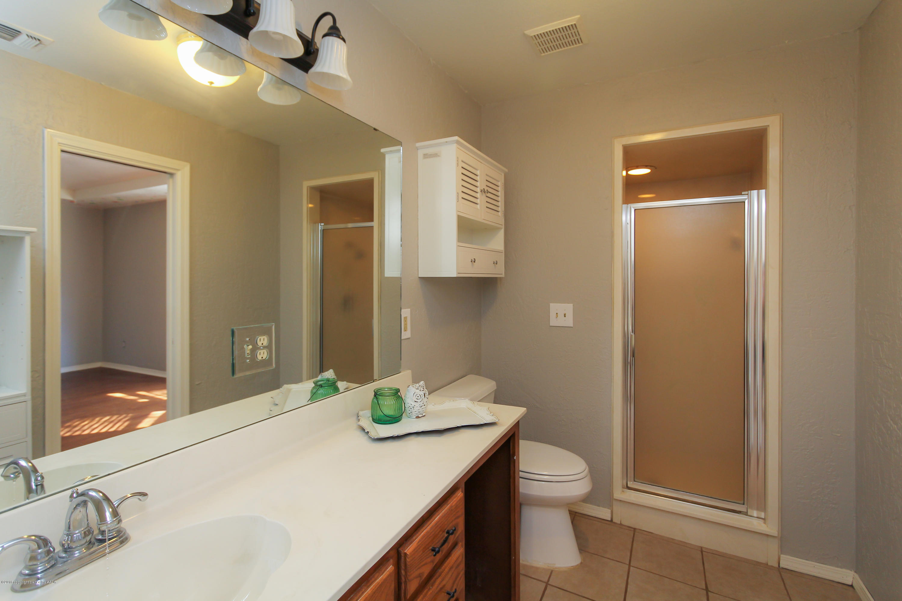 7915 Santa Fe Trail Amarillo, TX 79110 - Photo 38 of 57 a bathroom with a granite countertop sink toilet and shower