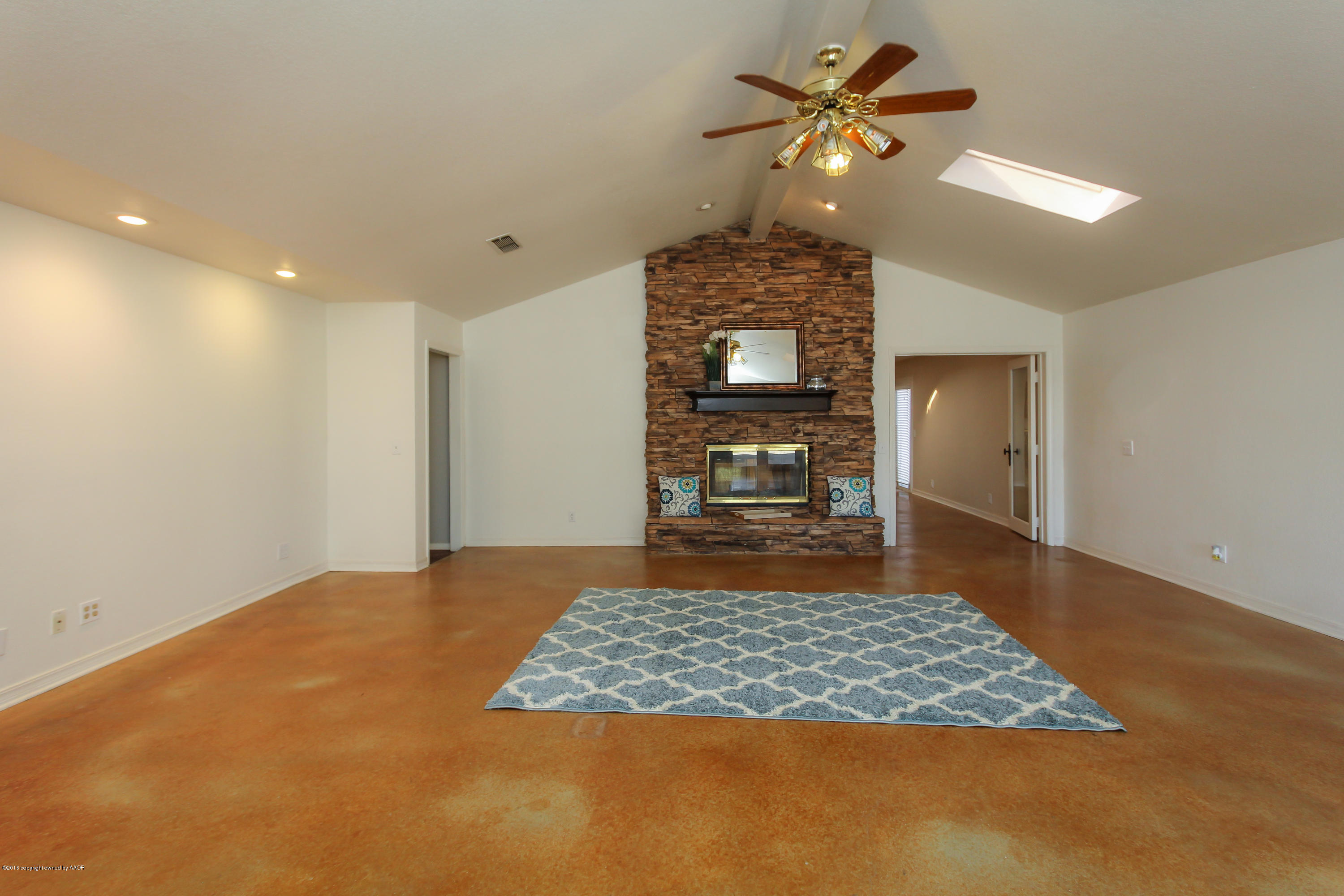 7915 Santa Fe Trail Amarillo, TX 79110 - Photo 40 of 57 a view of an empty room with a fireplace and a chandelier