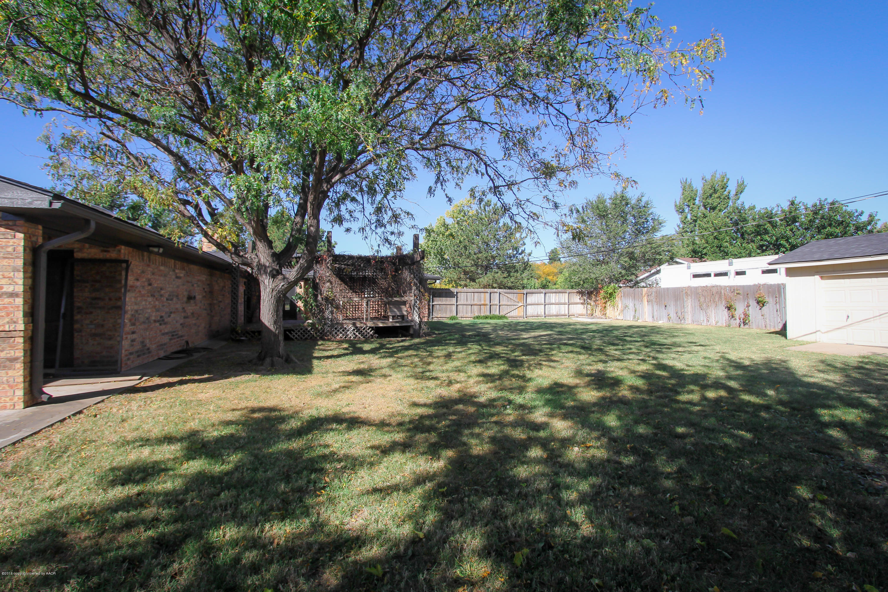 7915 Santa Fe Trail Amarillo, TX 79110 - Photo 5 of 57 a view of a backyard with large trees