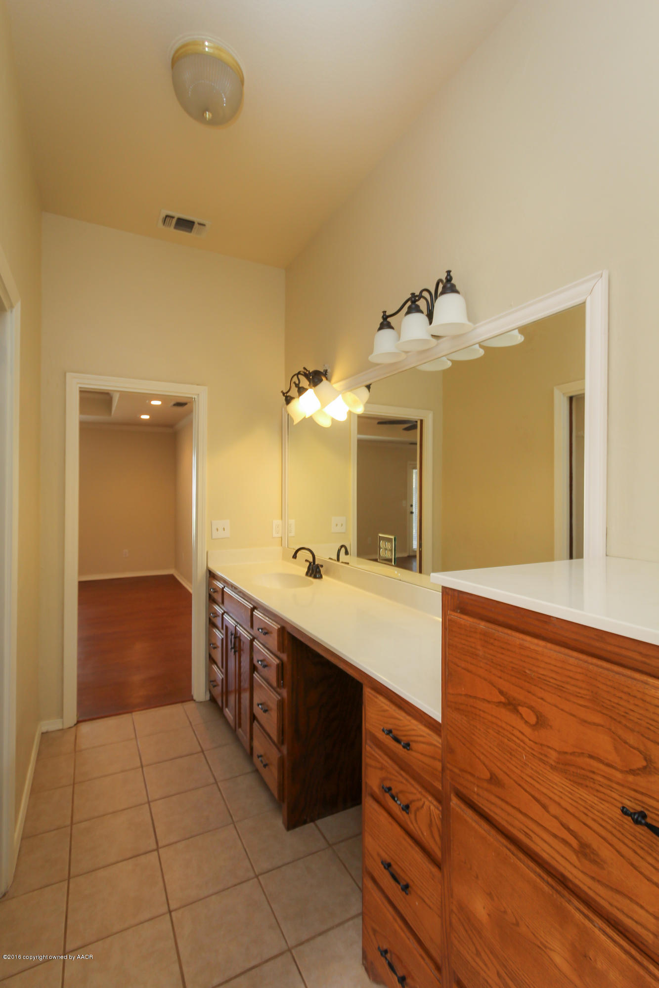 7915 Santa Fe Trail Amarillo, TX 79110 - Photo 47 of 57 a spacious bathroom with a granite countertop sink and a mirror
