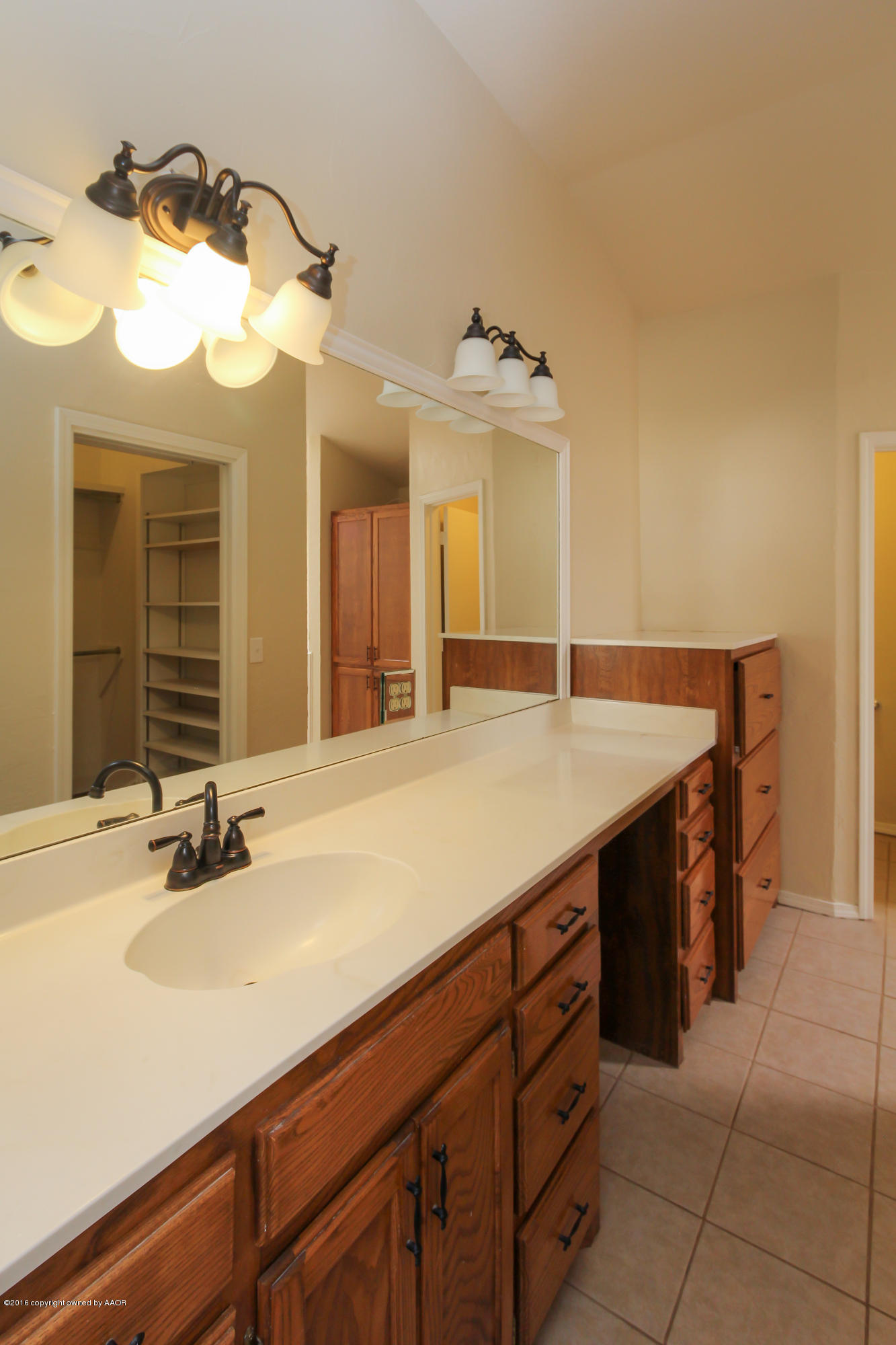 7915 Santa Fe Trail Amarillo, TX 79110 - Photo 48 of 57 a bathroom with a sink and a mirror