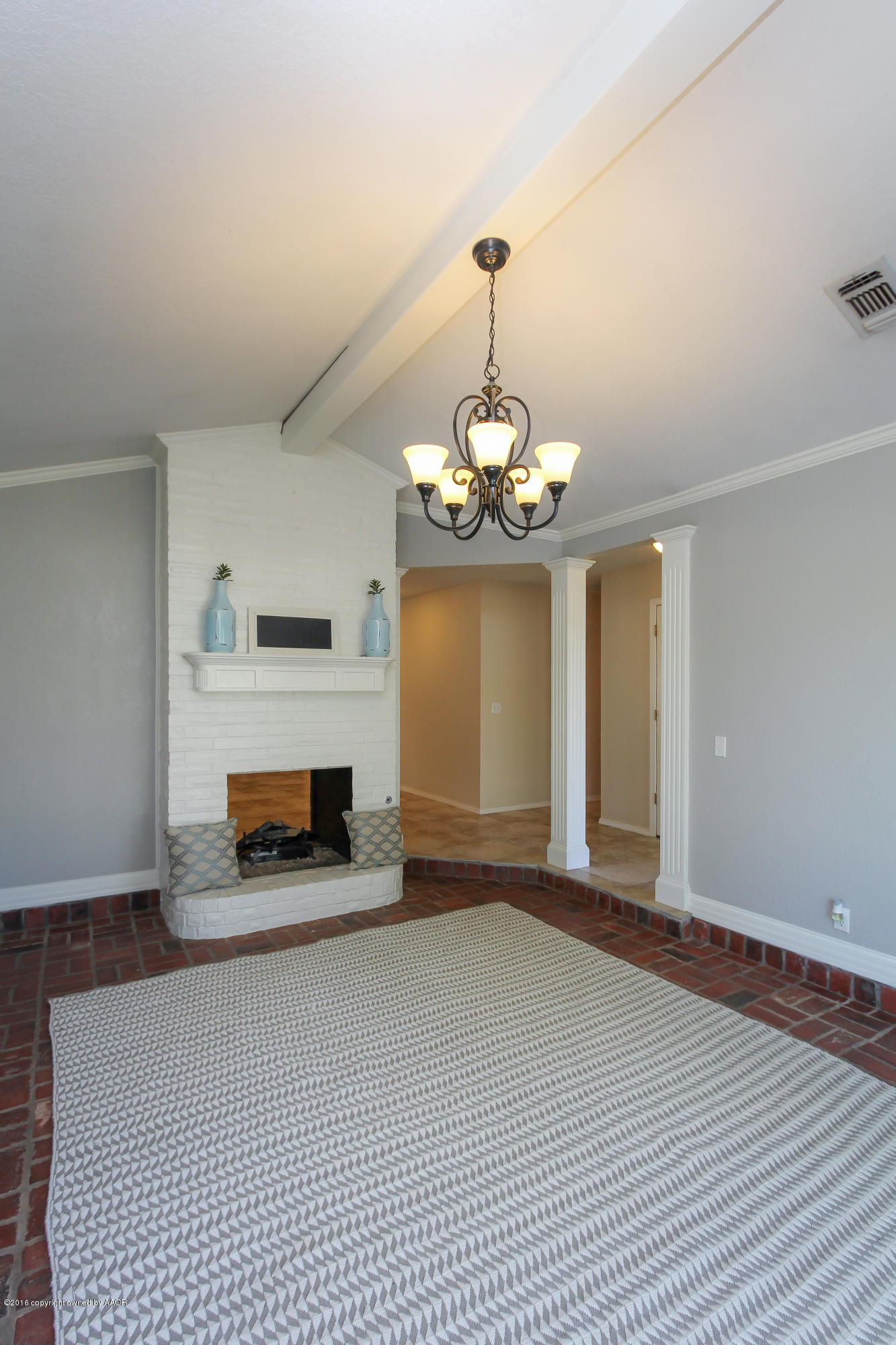7915 Santa Fe Trail Amarillo, TX 79110 - Photo 10 of 57 a view of a livingroom with a fireplace a chandelier and stairs
