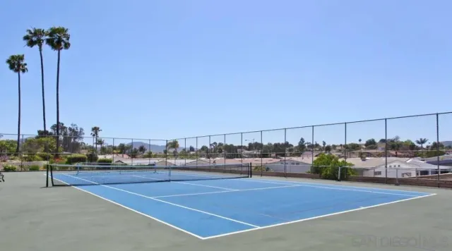 a dining room with furniture a chandelier and wooden floor