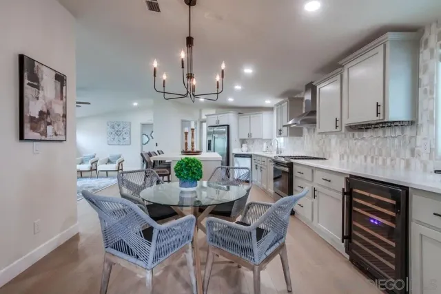 a kitchen with refrigerator a sink and chairs
