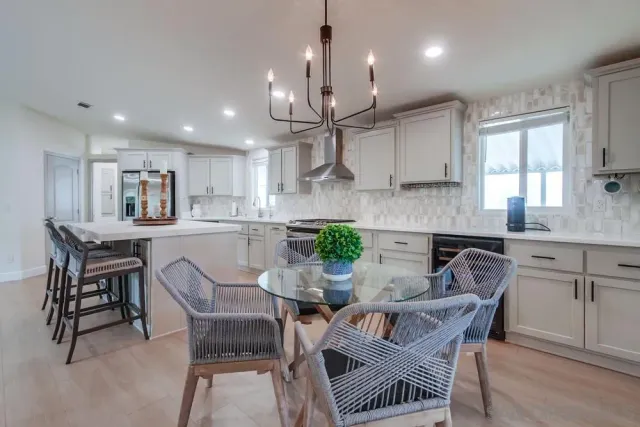 a spacious bathroom with a double vanity sink a mirror and a bathtub