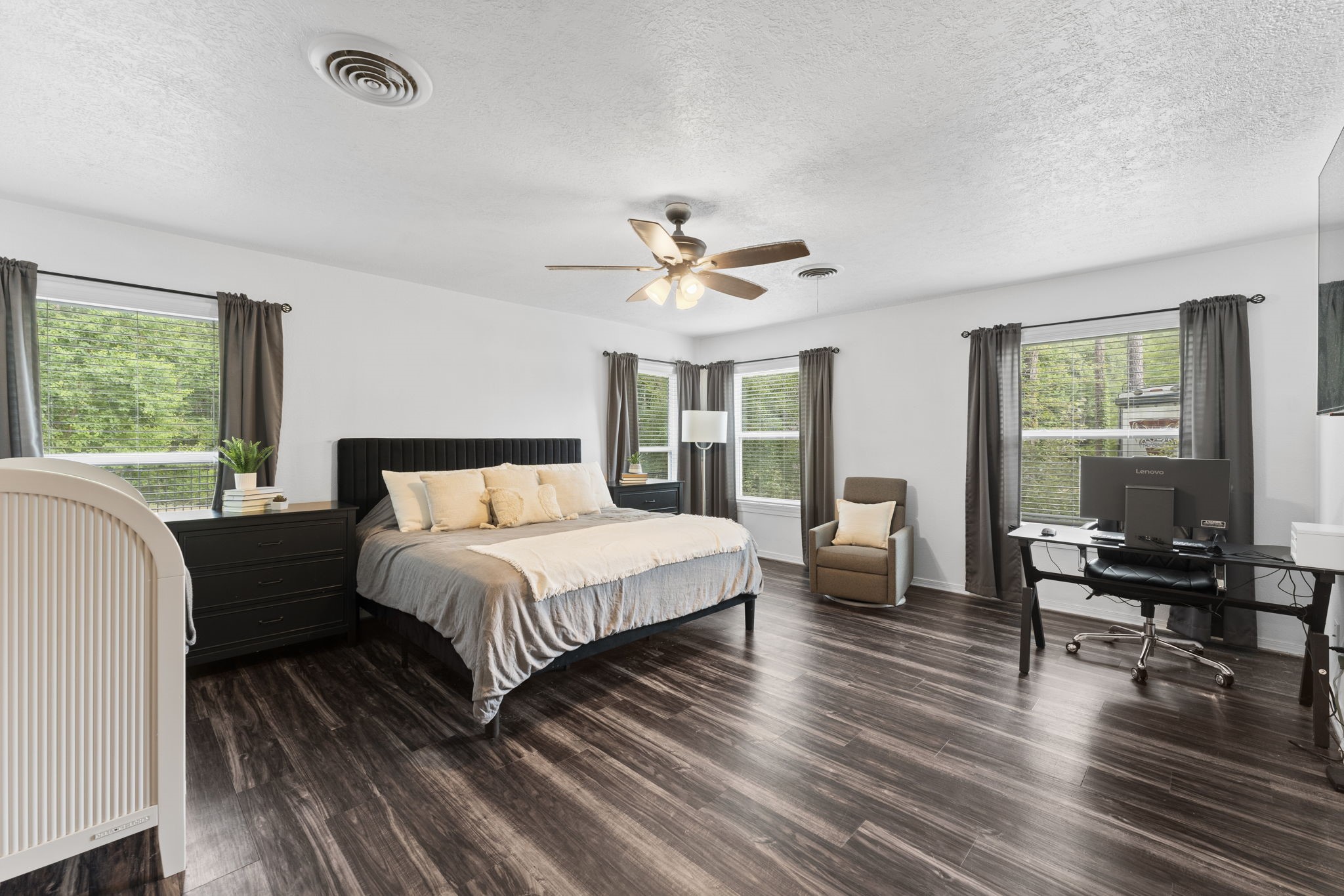910 Imperial Lane Houston, TX 77336 - Photo 13 of 26 a spacious bedroom with a bed a table and a large window