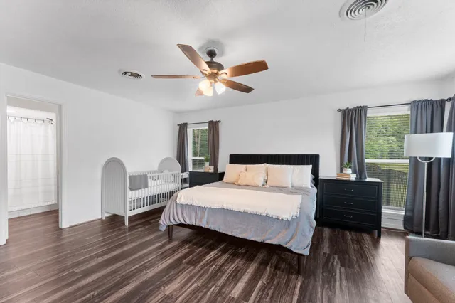 a bedroom with a bed lamp and a window