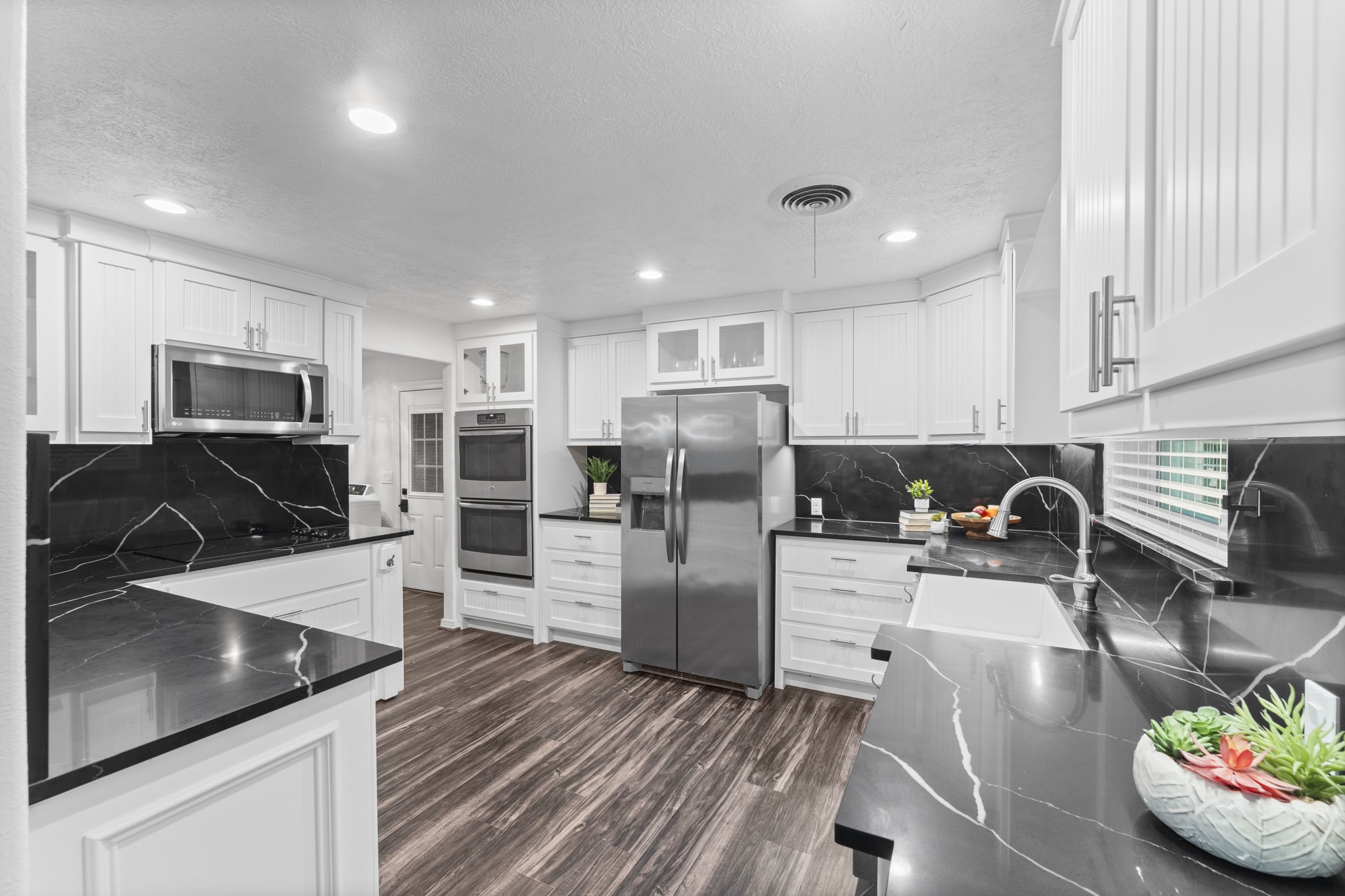 910 Imperial Lane Houston, TX 77336 - Photo 2 of 26 a kitchen with stainless steel appliances granite countertop a sink refrigerator and microwave