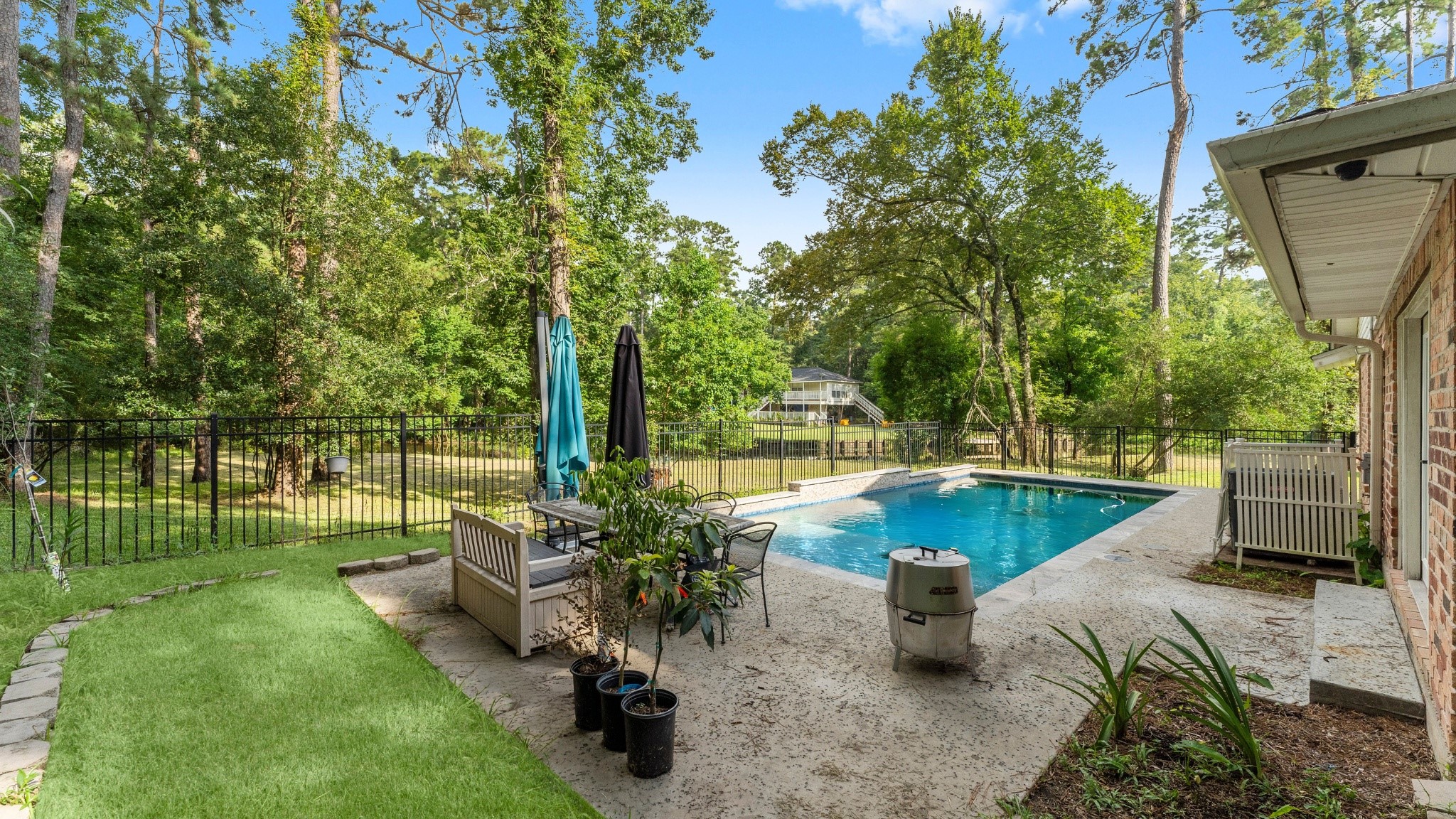 910 Imperial Lane Houston, TX 77336 - Photo 22 of 26 a view of a swimming pool with a patio and a garden