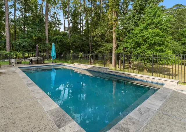 a view of a swimming pool with a patio