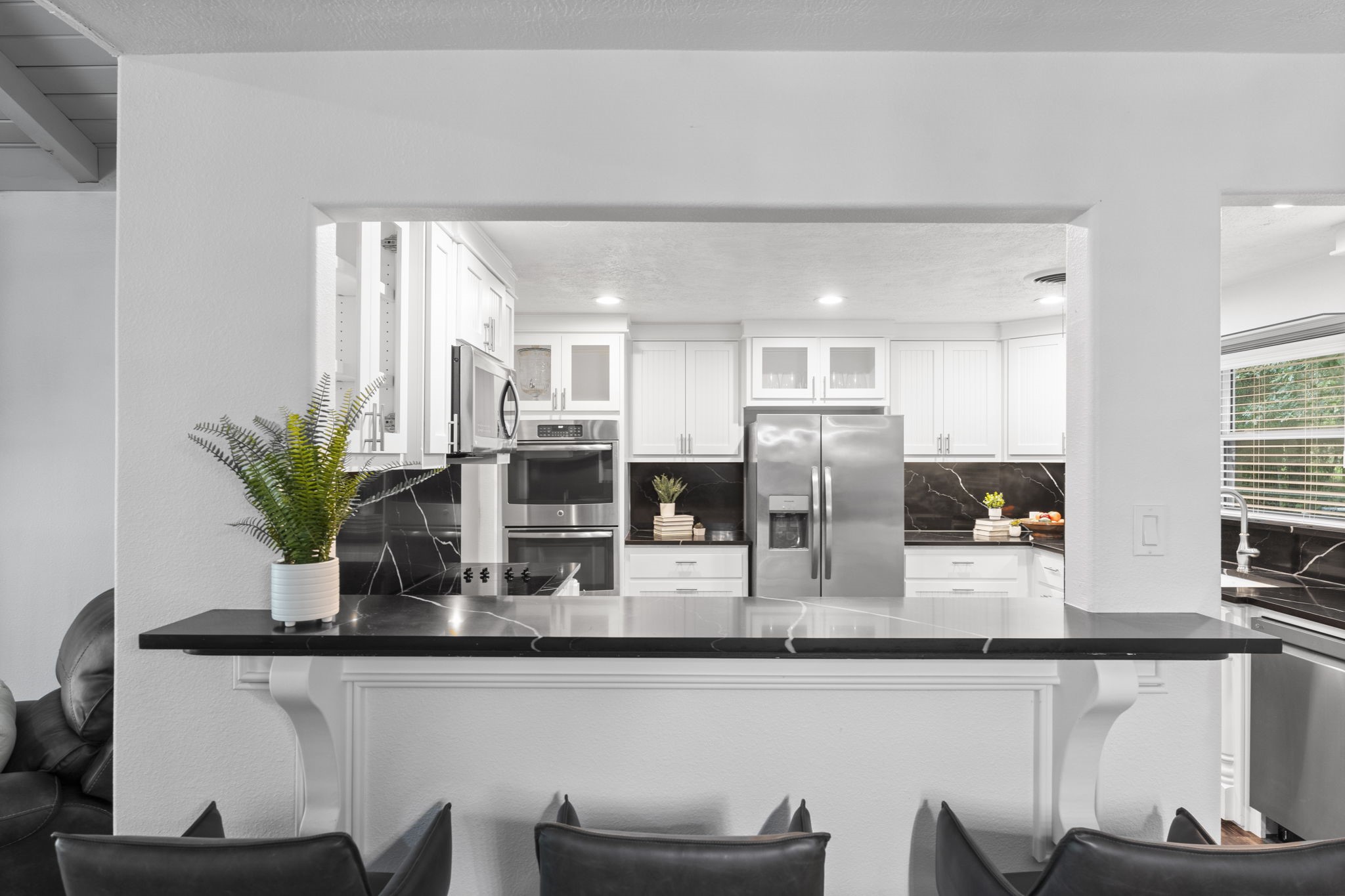 910 Imperial Lane Houston, TX 77336 - Photo 9 of 26 a kitchen with stainless steel appliances granite countertop a refrigerator a stove and white cabinets with wooden floor