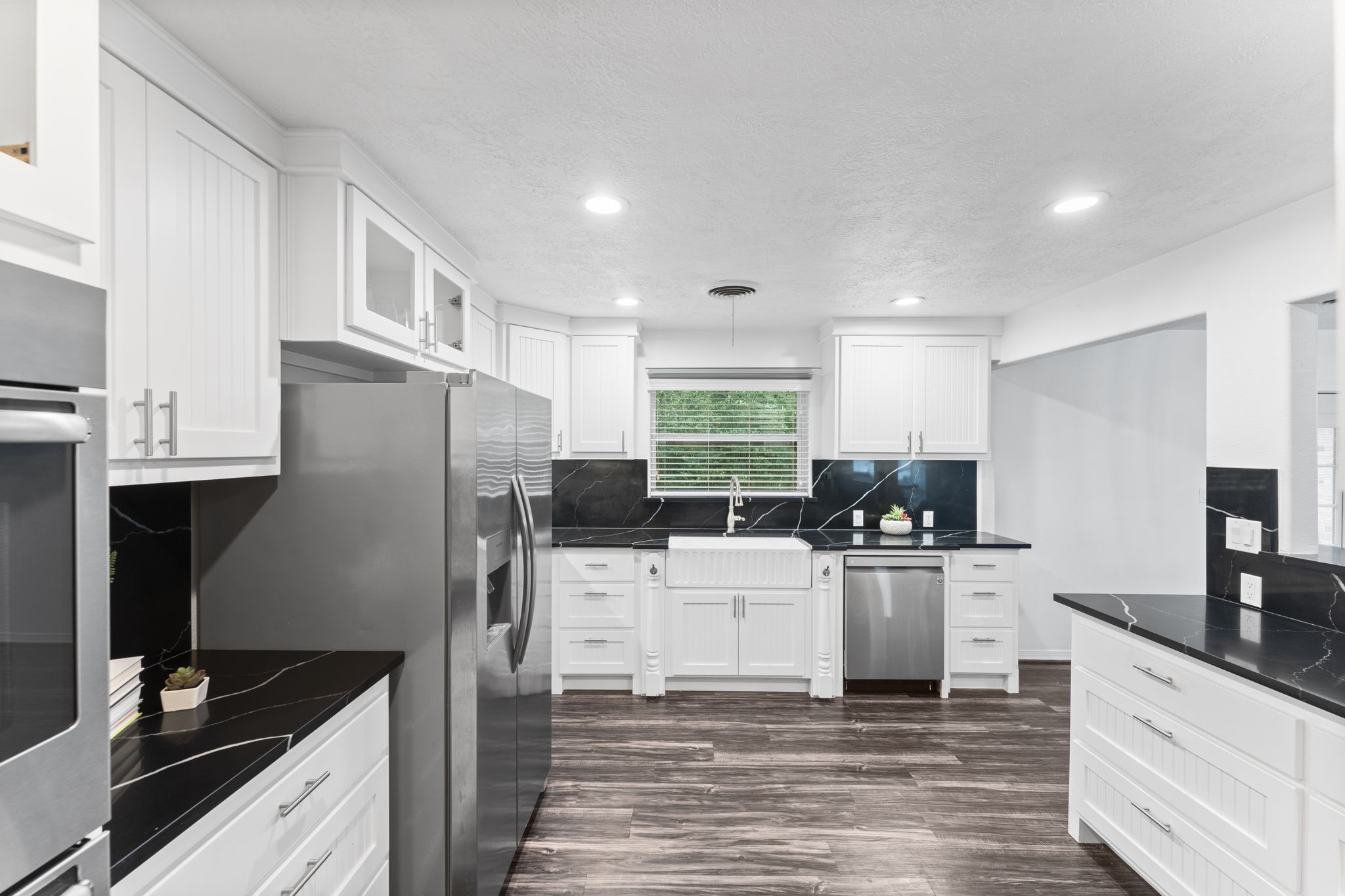 910 Imperial Lane Houston, TX 77336 - Photo 10 of 26 a kitchen with a refrigerator and a stove top oven