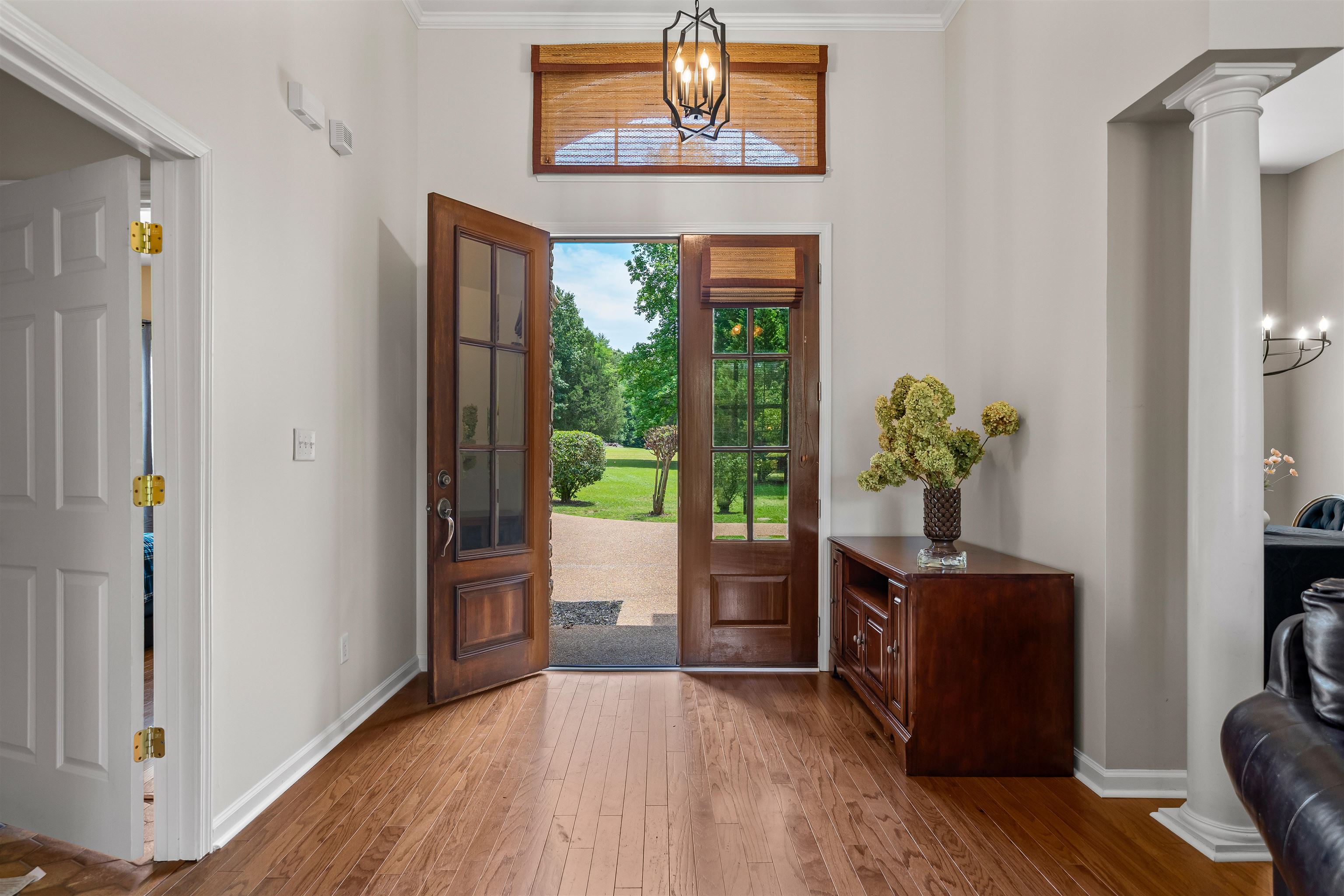5035 Brian Ridge Road Arlington, TN 38002 - Photo 16 of 40 Entryway featuring wood-finish flooring, a wood-paneled front door with multiple glass panes, and an overhead lighting fixture