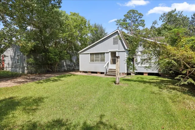 a front view of house with yard and green space