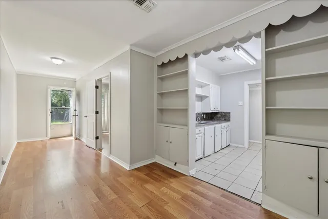 a view of walk in closet with empty racks