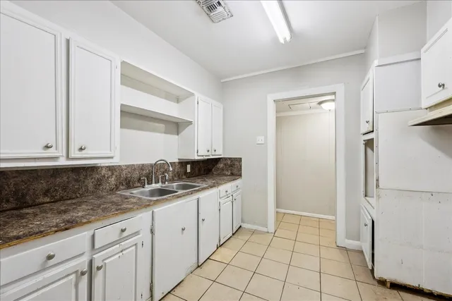 a kitchen with white cabinets