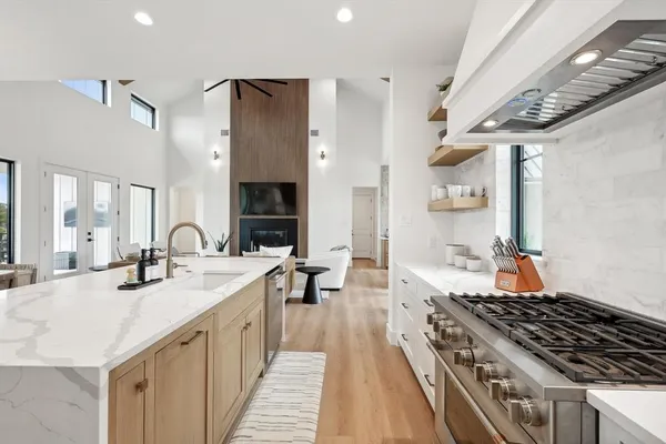 a kitchen with sink stove and chairs
