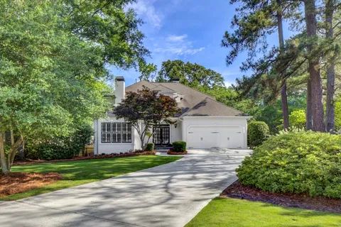 a front view of a house with a yard and a garage