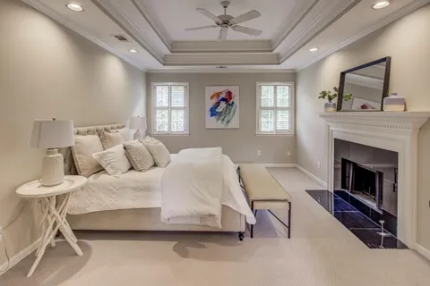 a spacious bedroom with a bed and a fireplace