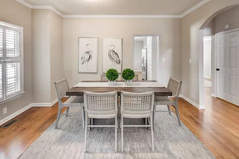 a dining room with furniture and wooden floor