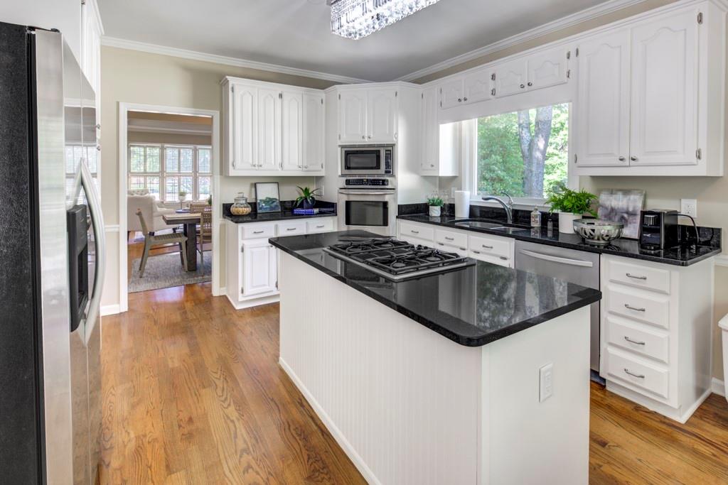 2059 Howell Mill Road Northwest Atlanta, GA 30318 - Photo 8 of 28 a kitchen with white cabinets and appliances