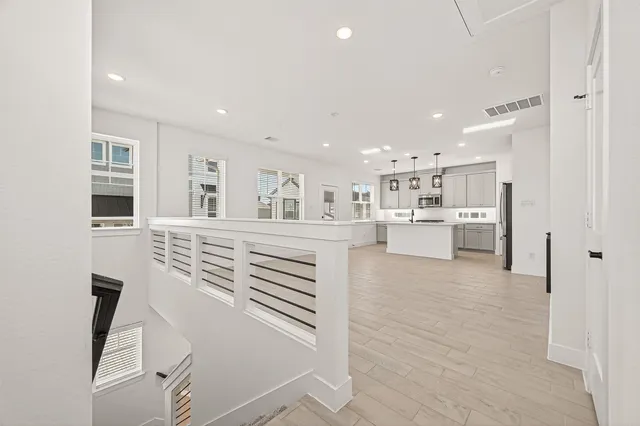 a living room with furniture and kitchen view