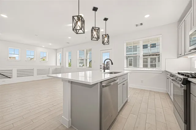 a kitchen with stainless steel appliances granite countertop a sink and stove