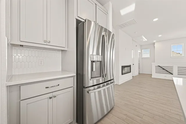 a kitchen with stainless steel appliances a refrigerator and cabinets