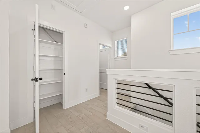 a view of walk in closet with empty racks