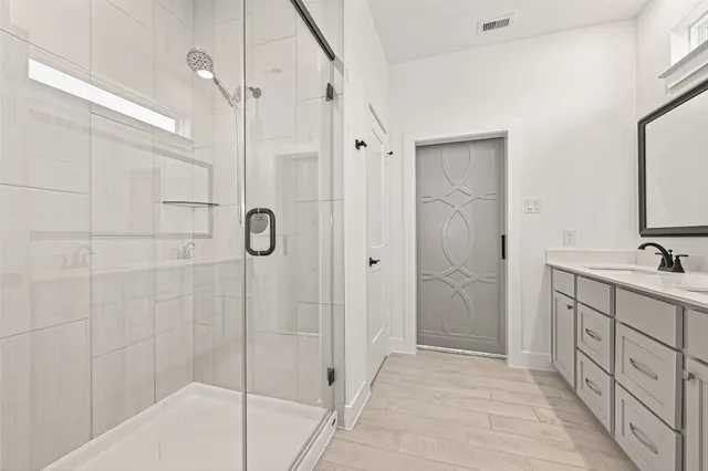 a bathroom with a shower and a sink