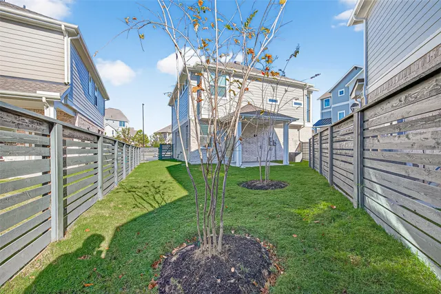 a view of a big house with a big yard and plants